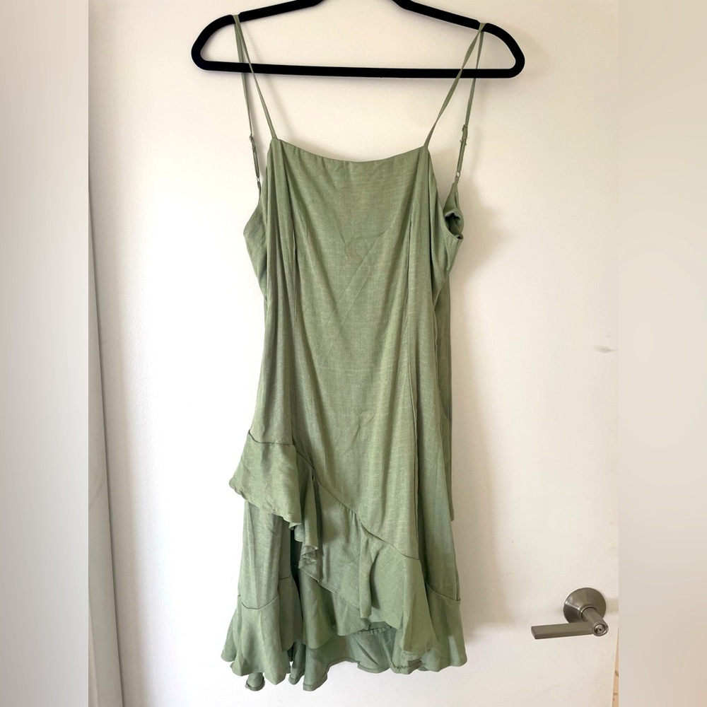 Green mini strap dress with open tie back